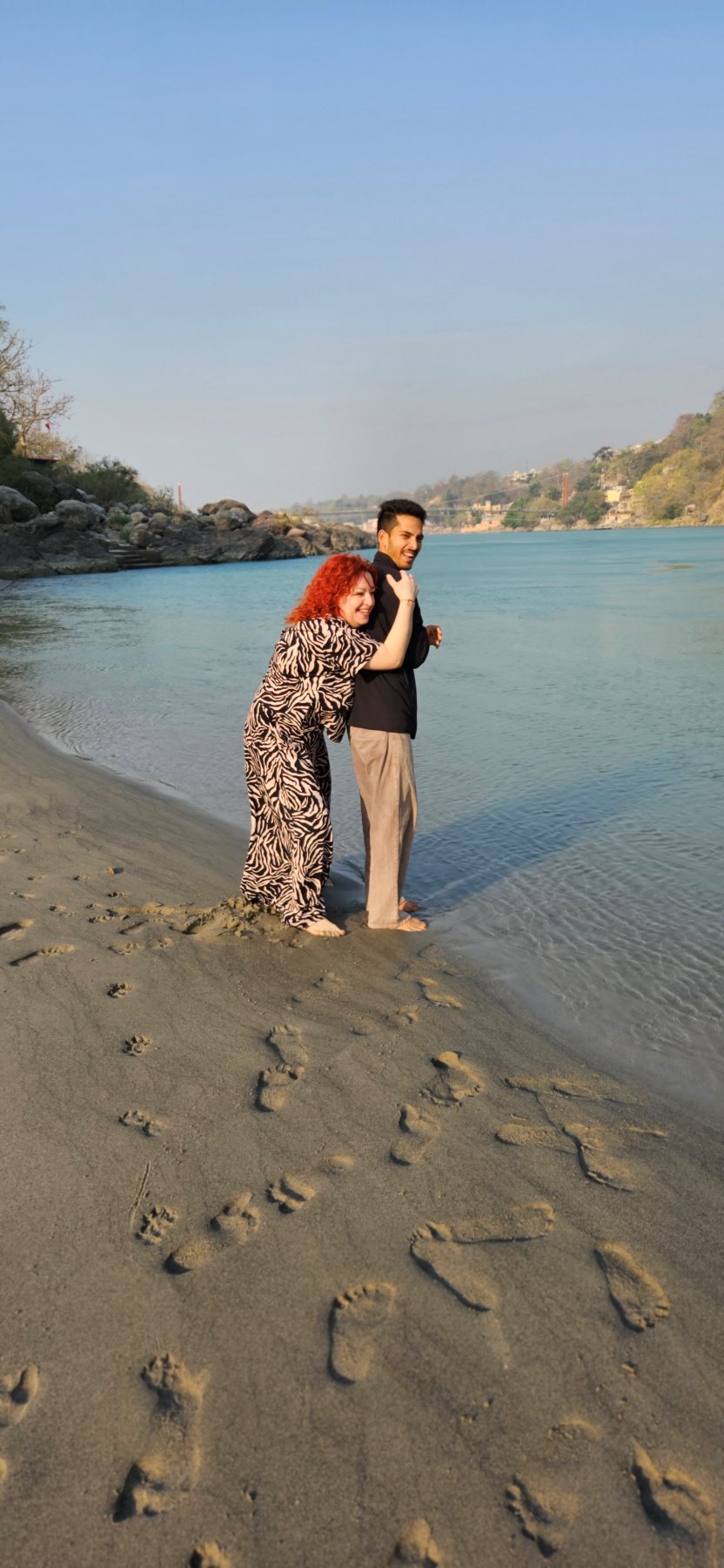 Two guests on the sandy riverbank of the Ganga