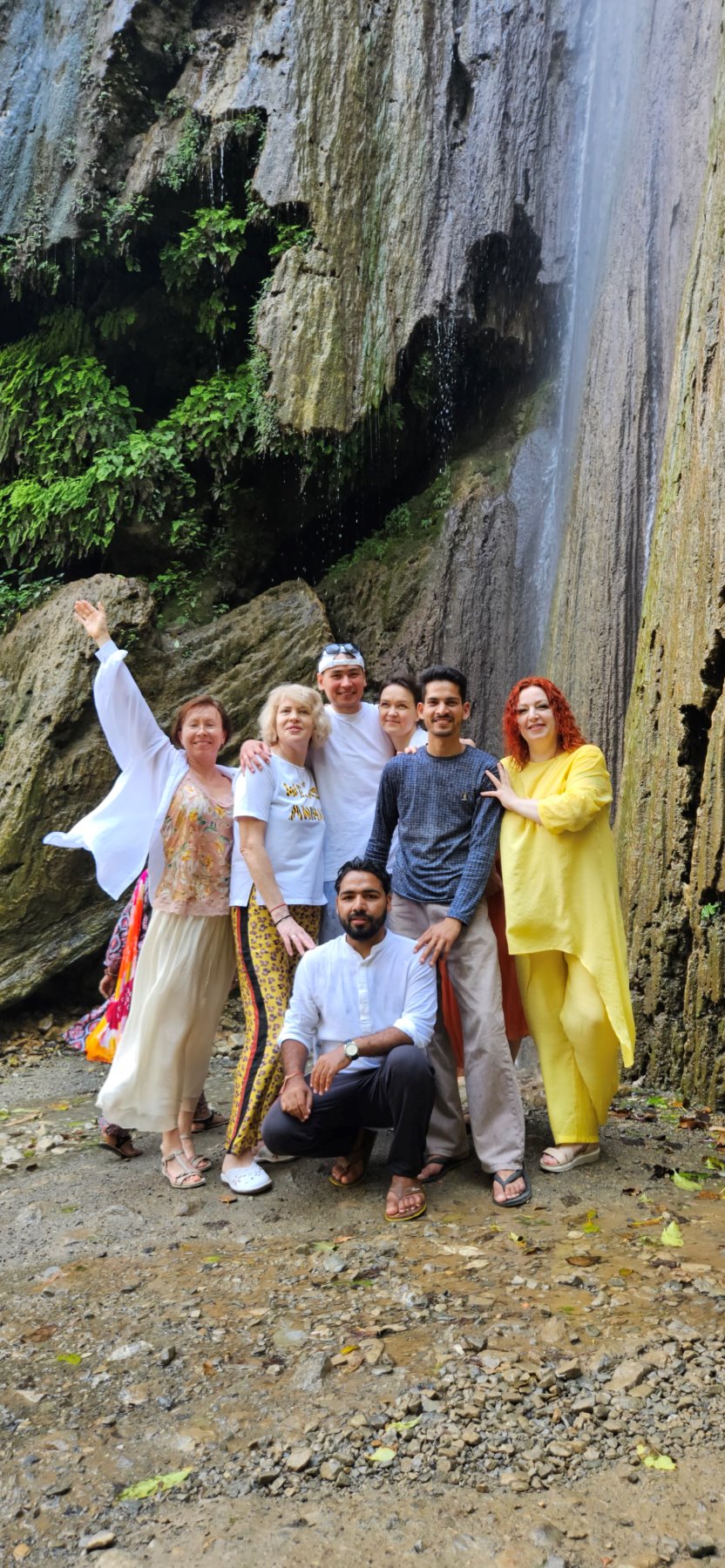 The group celebrating at the base of a waterfall