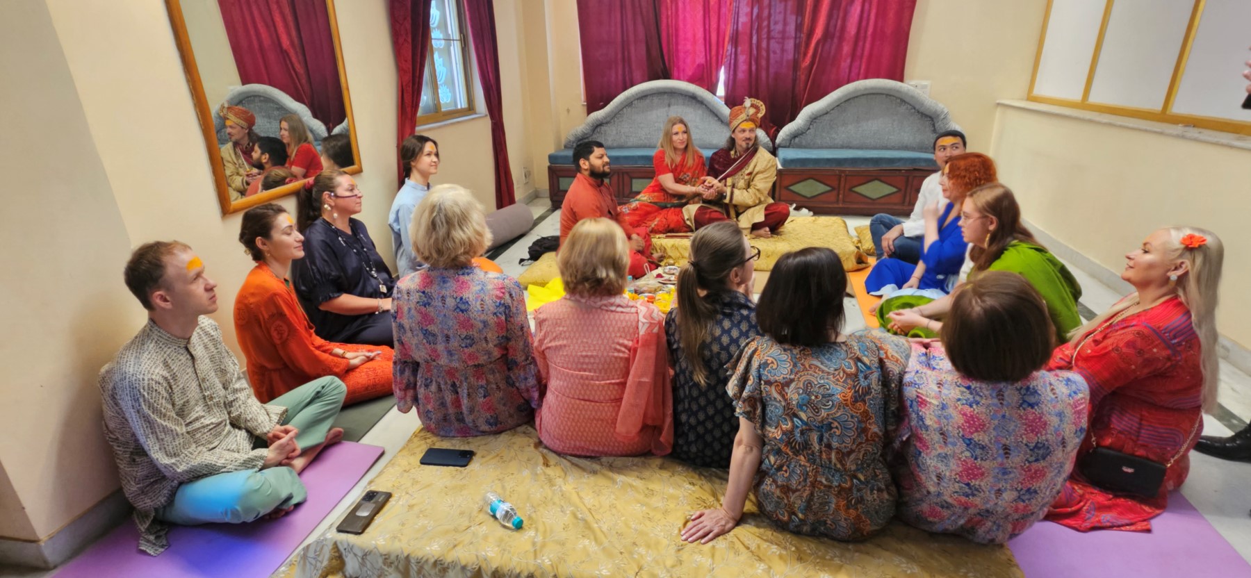 Guests seated for a traditional welcome ceremony, dressed in Indian attire
