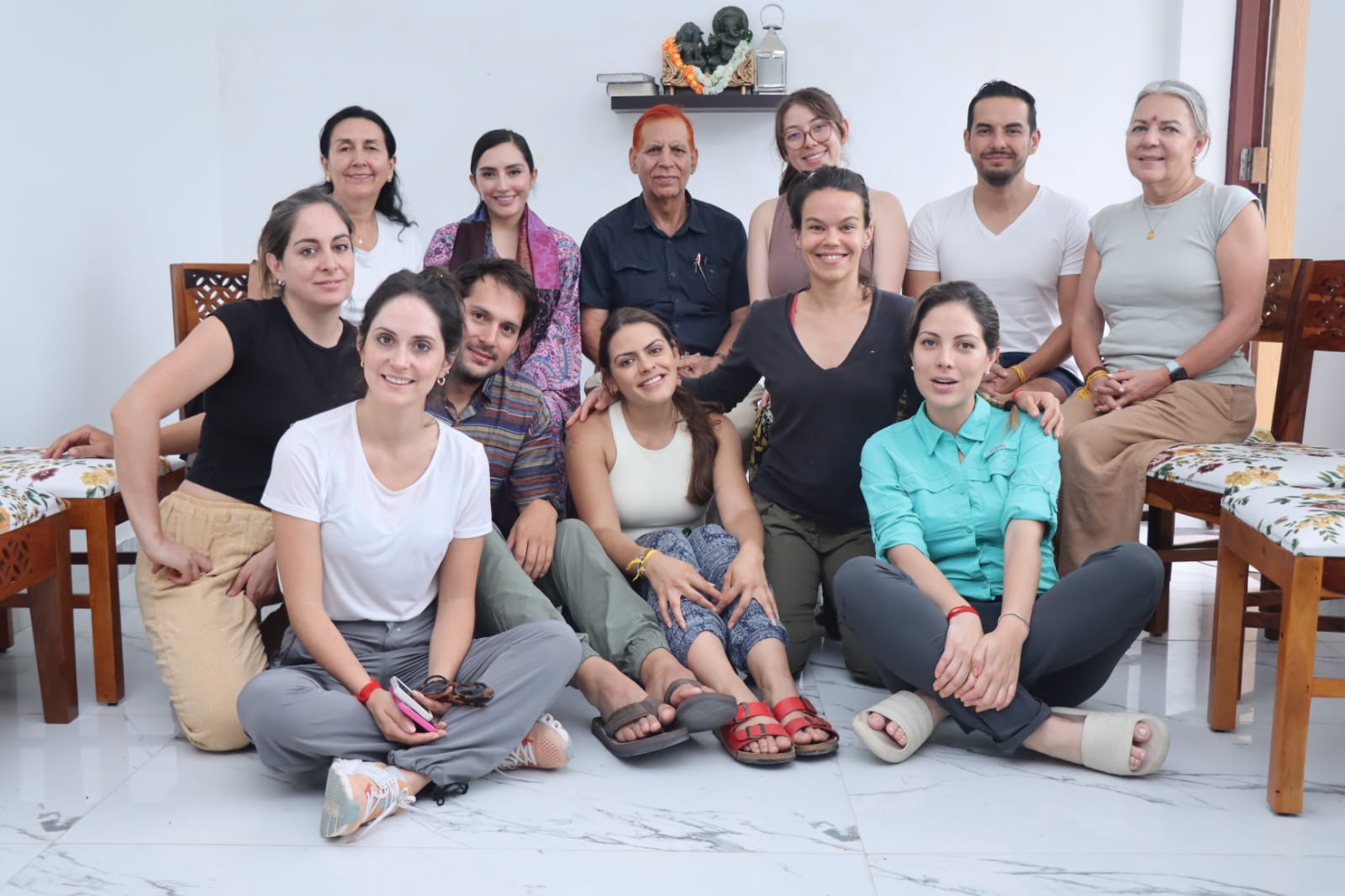 The group seated together indoors for a portrait