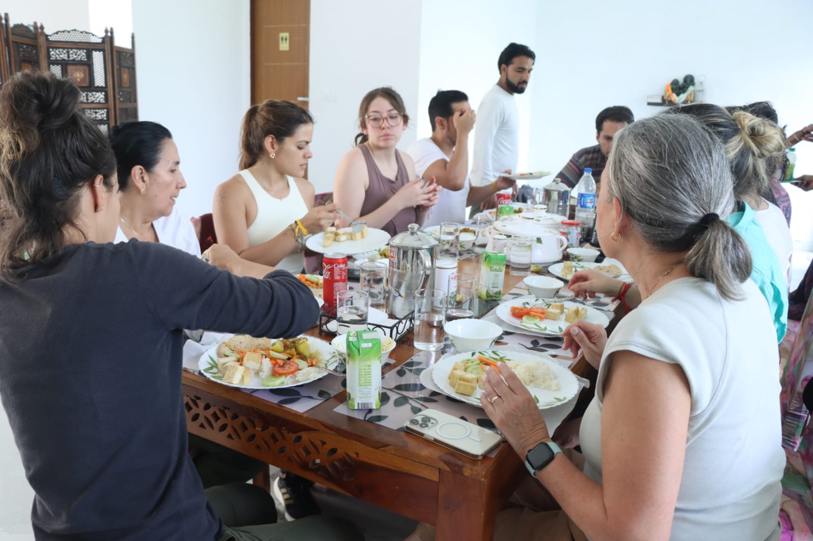 Guests sharing a sattvic meal together at the table