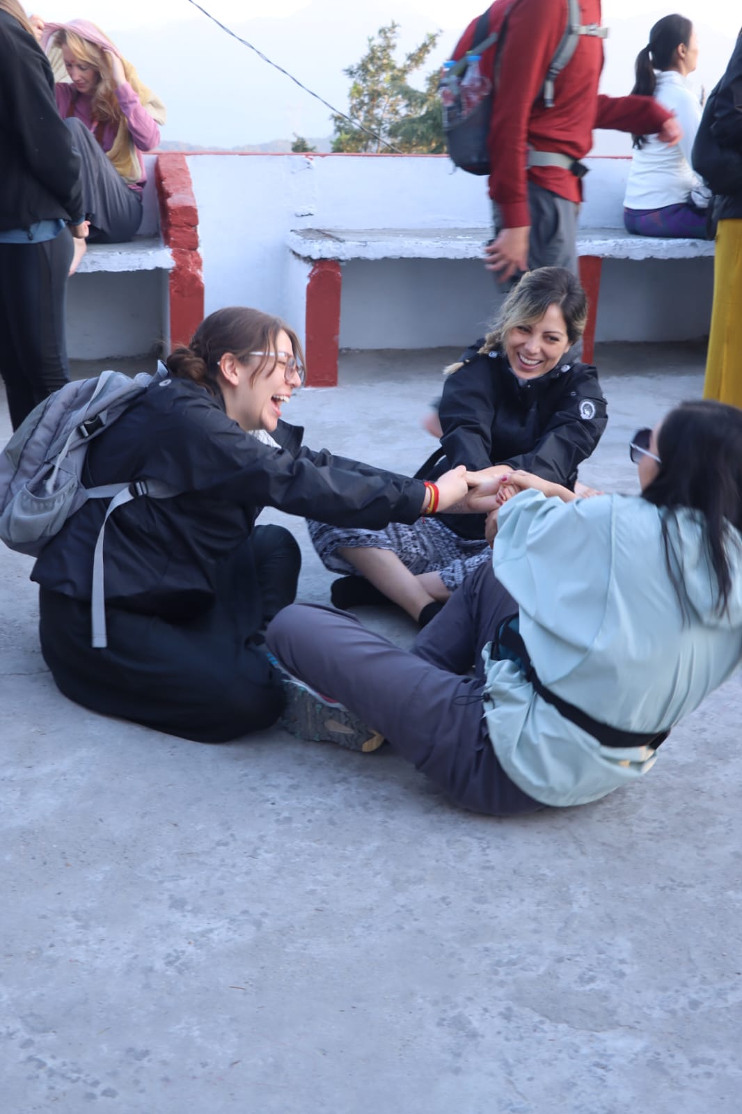 Guests laughing together on a rooftop during a trek stop