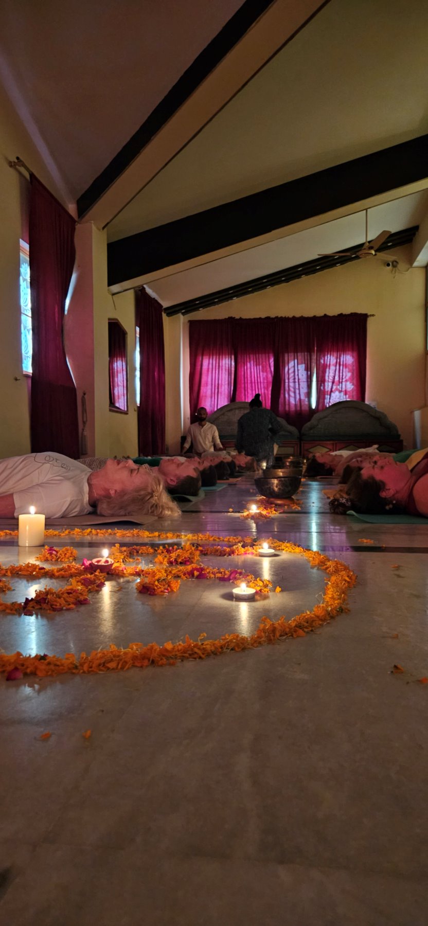 The group lying in savasana during a sound healing session
